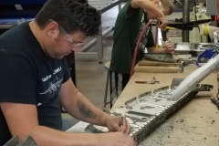 Founder Patrick Mihalek and youth Matt drilling rivets from B-25 parts.