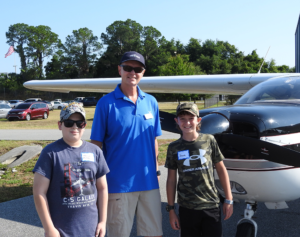 Young Eagle Mason McClintock, EAA pilot Roger Sturtevant, and Young Eagle Jaxon Orenzow.