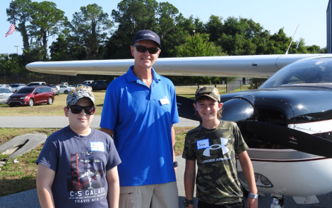 Young Eagle Mason McClintock, EAA pilot Roger Sturtevant, and Young Eagle Jaxon Orenzow.