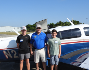 Young Eagle Keaton Maganoll, EAA Young Eagle chapter chief pilot Joel Hargis, and Young Eagle Isaac Willis.