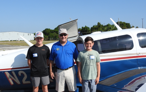 Young Eagle Keaton Maganoll, EAA Young Eagle chapter chief pilot Joel Hargis, and Young Eagle Isaac Willis.