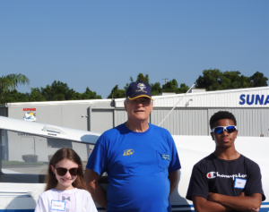 Young Eagle Gracie Abbott, EAA Chapter 534 pilot Marc Morel, and Young Eagle Jaden Crockwell.