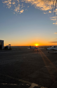 Sunset at an airfield with planes